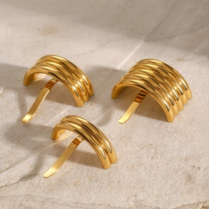 Polished gold U-shaped hair cuffs in multiple widths for elegant hair styling on stone