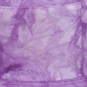 Detailed macro view of purple tie-dye cotton fabric with neat reinforced stitching