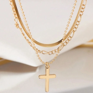 Three-layer gold multi-strand necklace with snake chain, bead chain and cross pendant