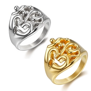 Detailed top view of gold and silver abstract Om symbol rings in polished stainless steel