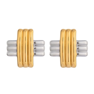 Detail shot of cross-design earrings featuring polished gold and silver metal textures