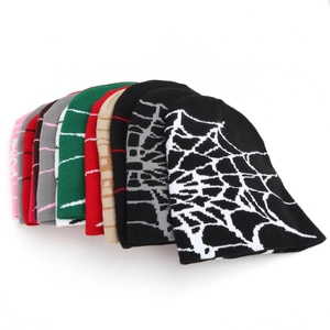 Close-up of colorful spider web jacquard knitted beanies in multiple vibrant colors