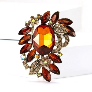Exquisite amber glass floral brooch with marquise gems on a geometric display stand