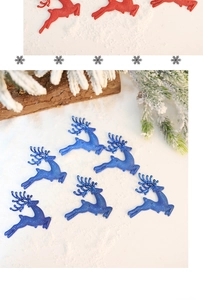Detailed view of red and blue Christmas reindeer ornaments on artificial snow background
