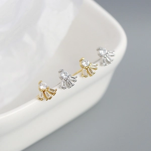 Macro shot of gold and silver S925 sterling silver earrings with square zircon crystals