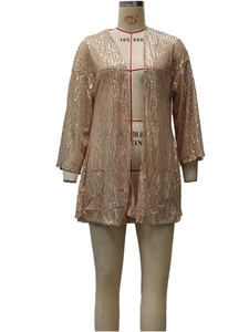 Close-up of champagne gold sequined fabric texture on a long sleeve open front cardigan