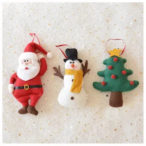 Three-piece felt Christmas ornaments set with Santa, snowman, and tree on white fur background