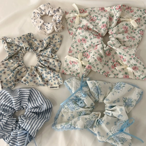 Flat lay view of five Korean style lace hair scrunchies with floral and stripe patterns