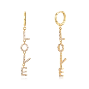Close-up of golden LOVE drop earrings featuring sparkling rhinestones on white background