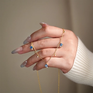 Elegant gold S925 sterling silver necklace with blue square zircon pendant held by hand