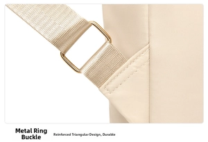 Detail of beige backpack showing reinforced triangular stitching and gold metal hardware