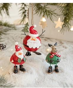 Close-up of Santa Claus and reindeer iron ornaments in a warm snowy Christmas scene