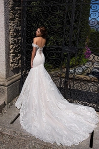 Lace mermaid wedding dress with off-shoulder neckline and lace-up back detail
