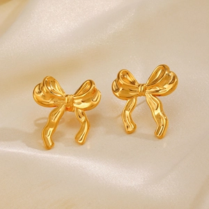 Paire de boucles d'oreilles nœud en acier inoxydable plaqué or 18K sur satin crème