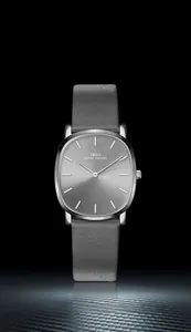 Detail of minimalist ultra-thin men's watch with grey leather strap and sunray oval dial