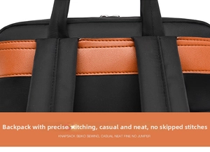 Detail of durable black canvas and brown leather stitching on a laptop backpack