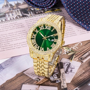 Macro shot of gold watch with green Roman dial and diamond bezel on a vintage magazine