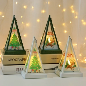 Christmas pyramid lanterns with reindeer and tree patterns on decorative vintage books