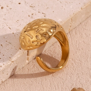 Détail macro d'une bague en acier inoxydable plaqué or 18 carats avec texture martelée