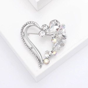 Elegant silver heart-shaped brooch with sparkling rhinestones in a minimalist 45-degree view