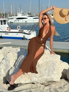 Detail of brown mesh maxi dress with side slit and decorative golden starfish on waist