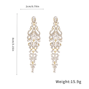Detailed view of crystal tassel earrings with gold finish and 8cm length measurements