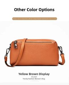 Detail of yellow brown lychee pattern leather crossbody bag with dual zipper design
