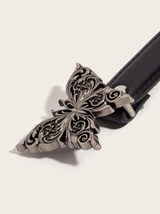 Close-up of vintage silver butterfly metal buckle on a black leather belt for jeans