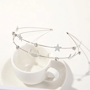 Detail shot of silver double-layered headband featuring star and moon charms with rhinestones