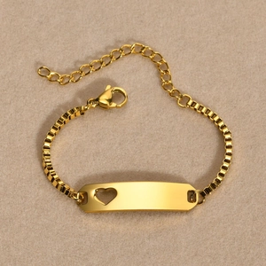 Detail of gold stainless steel bar bracelet with heart cutout and Venetian box chain