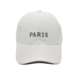 Detailed close-up of grey PARIS embroidery on a premium white cotton baseball cap