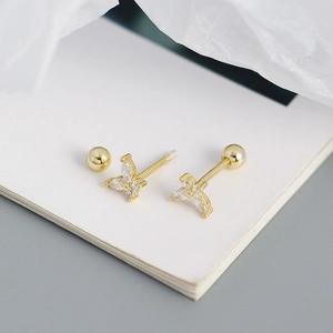 Detailed macro of golden butterfly screw back earring with sparkling zircon stones
