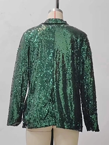Back view of a green sequined blazer jacket with long sleeves on a mannequin