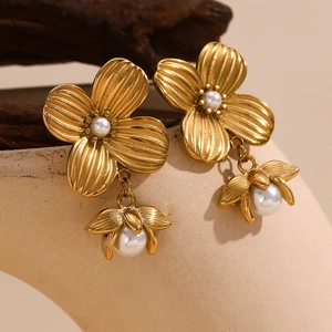 Detailed macro shot of 18K gold plated flower earrings with elegant white pearls