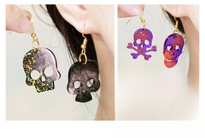 Glittery skull earrings shown on model showcasing resin DIY jewelry design