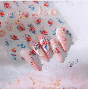 Detail of 3D embossed nail stickers featuring red roses and white dragon motifs