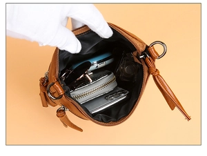 Brown leather crossbody bag interior showing storage space for phone and essentials
