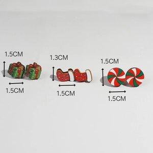 Detailed view of Christmas earrings featuring gift box, stocking, and candy patterns