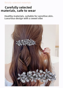 Detail of floral spring hair clip featuring grey petals and synthetic pearls