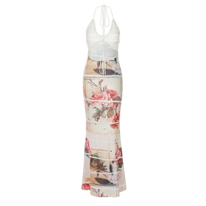 Detail of white knit halter dress featuring floral print and striped maxi length skirt