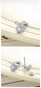 Detailed macro view of silver bow and zircon starfish earrings with secure screw backs