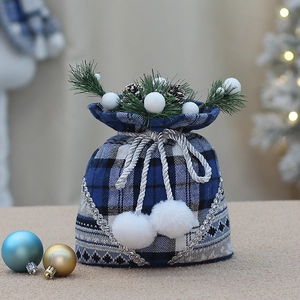 Blue plaid Christmas drawstring bag with pine needles, pinecones and white pom-poms