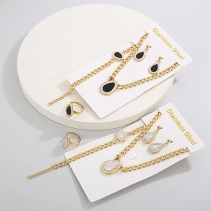 Detailed set of stainless steel jewelry featuring teardrop shell stones and gold finish