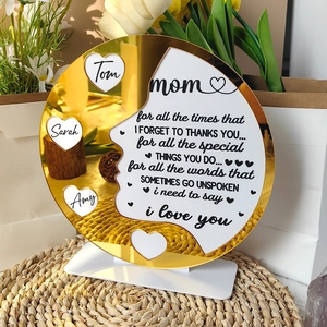 Macro shot of custom acrylic Mother's Day plaque with golden mirror finish and names