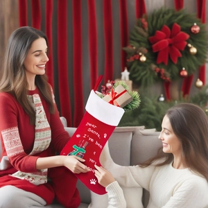 Detail of red velvet Christmas stocking with white faux fur cuff and pet paw print