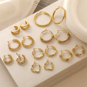 Collection of gold-plated C-shaped earrings in various geometric and textured designs