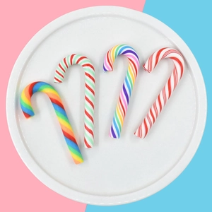 Top view of four striped resin candy canes in rainbow, red, and green for DIY crafts