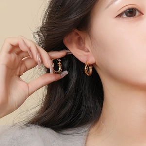 14k gold plated leopard print hoop earrings with clear zircon stones on model