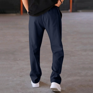 Detail view of navy blue straight-leg trousers with premium drape and back fabric texture
