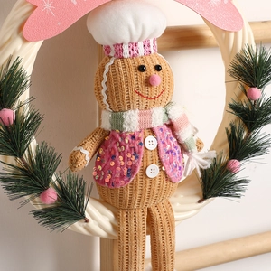 Christmas gingerbread man wreath with knitted doll, chef hat, and pine needles door decor